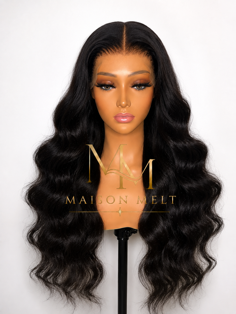 Black wavy wig on a mannequin head with 'Maison Melt' logo.