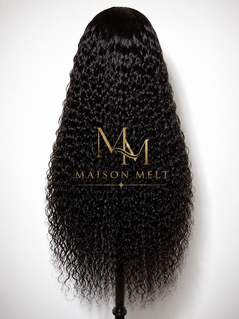 Black curly wig on a mannequin head with 'Maison Melt' logo.