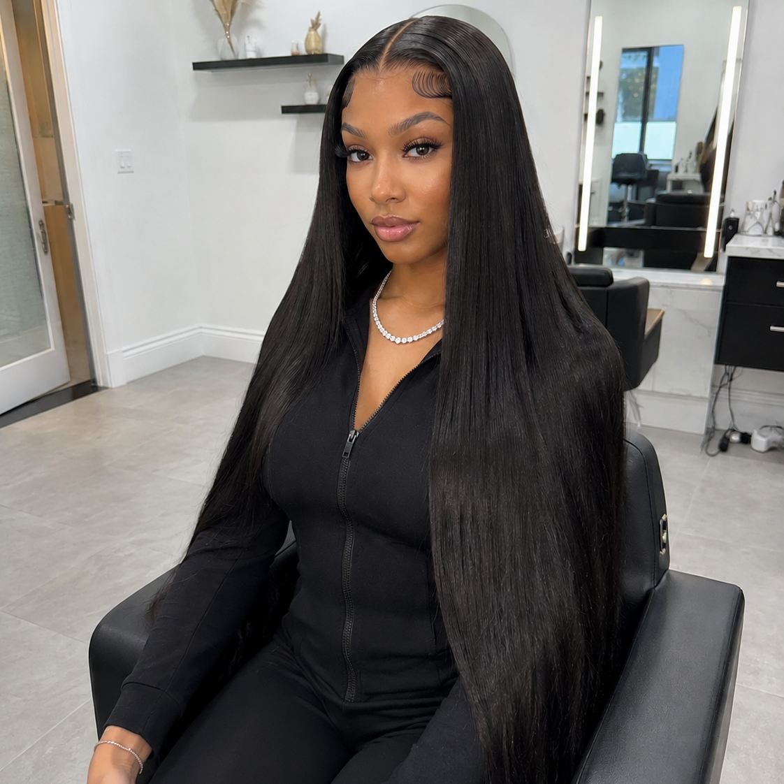 Girl sitting in a salon chair with long straight hd lace wig